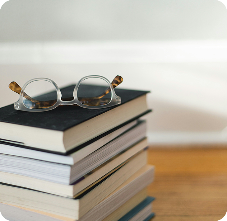 A stack of books and glasses